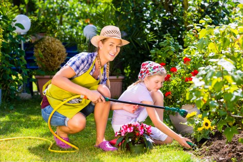 Close-up of hands arranging plants for gardening services in Alperton